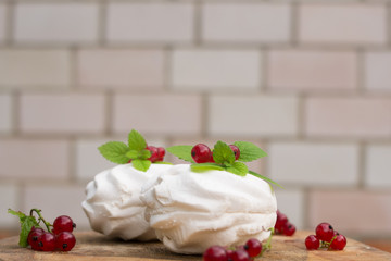 Homemade pink marshmallow and pavlova cake with strawberry, blackberry, currant, cherry and mint leaf.