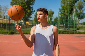 Young man playing with basketball