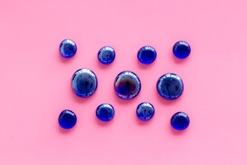 Shiny glass stones for decoration, creativity and craft on pink background top view