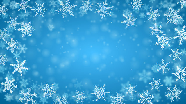 Christmas background of complex blurred and clear falling snowflakes in light blue colors with bokeh effect