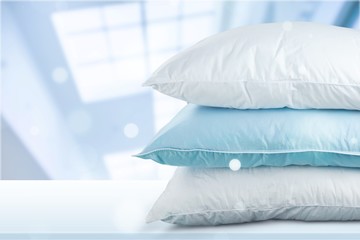 Soft Pillows Pile on grey background, three pillow, sleeping items.