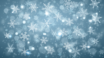 Christmas background of complex blurred and clear falling snowflakes in light blue colors with bokeh effect
