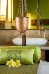 Ayurveda spa treatment copper vessel for shirodhara, oil-dripping treatment setup, no people.	