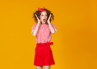 concept happy emotional young woman in red  jumping   on yellow background.