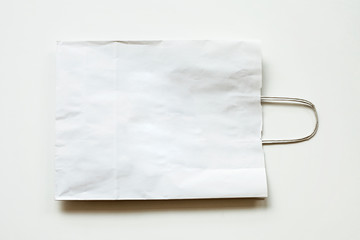Blank paper carrier bags with handles for shopping.