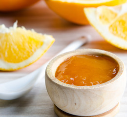 Orange jam served in spoon on the table