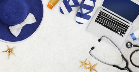 holiday summer sea medical insurance concept, stethoscope,computer,flip flop, sunscreen, hat and...