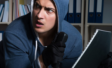Young man in industrial espionage concept