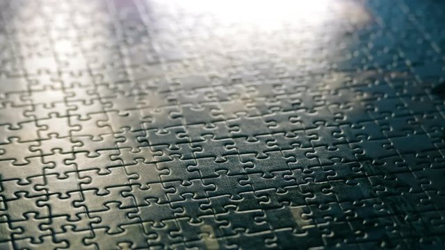 Focusing at the middle of complete jigsaw puzzle. Focus moves from bottom and stops at the center