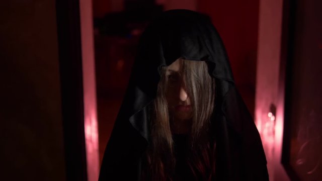 a girl with long black hair in a dark corridor. Horror maniac concept. Halloween