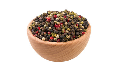 colored pepper peppercorns in wooden bowl isolated on white background. 45 degree view. Spices and food ingredients.