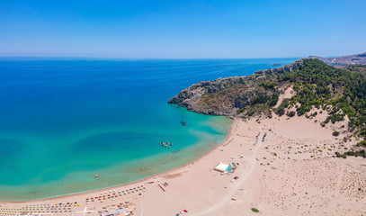 Fototapeta premium Aerial birds eye view drone photo Tsambika beach near Kolympia on Rhodes island, Dodecanese, Greece. Sunny panorama with sand beach and clear blue water. Famous tourist destination in South Europe