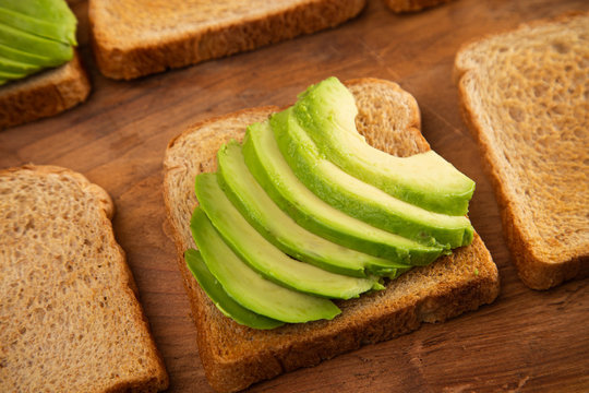 Six Pieces of Avocado Toast on a Rustic Wooden Table