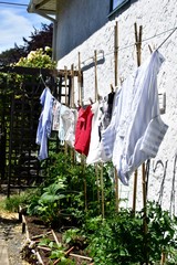 Summer outdoors with fresh environmentally friendly drying clothes on outdoor clothesline