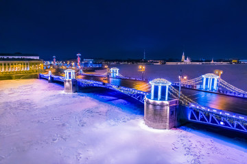 Saint Petersburg, Russia. New Year's Palace Bridge. Frozen Neva. Panorama of the city in winter. Night illumination of the Palace Bridge. St. Petersburg at night on Christmas. New Year in SPb.