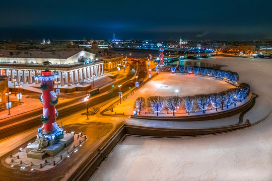 Saint Petersburg, Russia. Night panorama of SPb in the winter. Vasilievsky Island in New Year. Christmas lights Rostral columns. Winter Neva. Streets of SPb in the winter. Exchange building at night.
