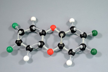 Obraz premium Molecule model of Dioxine. Black is Carbon, red is Oxygen, green is Chlor, white is Hydrogen