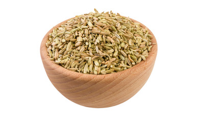 fennel seeds in wooden bowl isolated on white background. 45 degree view. Spices and food ingredients.