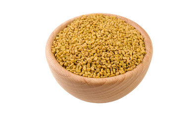 fenugreek seeds in wooden bowl isolated on white background. 45 degree view. Spices and food ingredients.