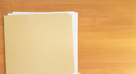 Folder with documents on a wooden table close-up top view