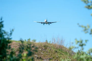 Fototapeta na wymiar Landing airplane silhouette on final approach at EFHK