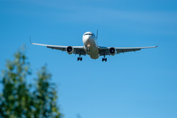 Fototapeta na wymiar Landing airplane silhouette on final approach at EFHK