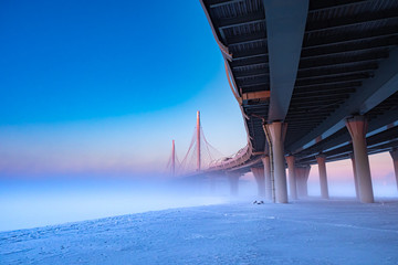 Modern highway. Highway on stilts. speedway along the frozen coast. Expressway on a foggy winter...