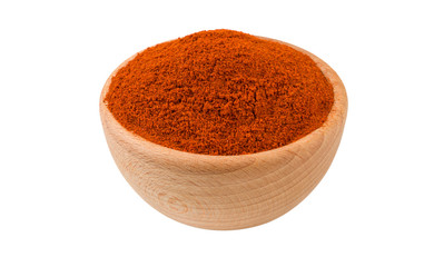 milled or ground paprika or red pepper in wooden bowl isolated on white background. 45 degree view. Spices and food ingredients.