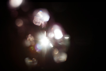 Lens Flare. Light over black background. Easy to add overlay or screen filter over photos. Abstract...