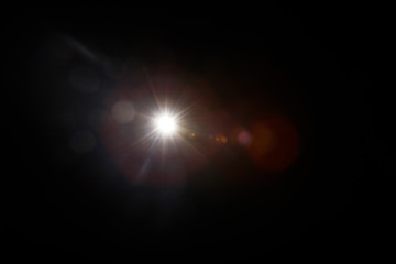 Lens Flare. Light over black background. Easy to add overlay or screen filter over photos. Abstract sun burst with digital lens flare background. Gleams rounded and hexagonal shapes, rainbow halo.