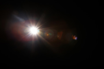 Lens Flare. Light over black background. Easy to add overlay or screen filter over photos. Abstract...