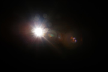 Lens Flare. Light over black background. Easy to add overlay or screen filter over photos. Abstract...