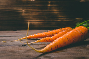 Fresh tasty carrots on a wooden rustic table. Healthy food. Vegetables.