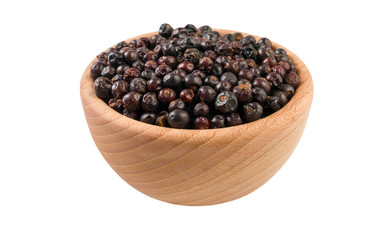 juniper berries in wooden bowl isolated on white background. 45 degree view. Spices and food ingredients.