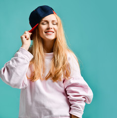 Sexy beautiful woman wearing baseball cap on blue mint 