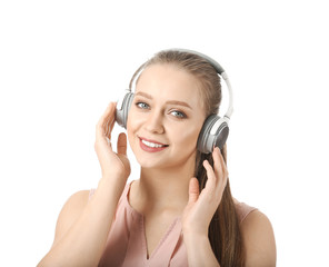 Fototapeta premium Beautiful young woman listening to music on white background