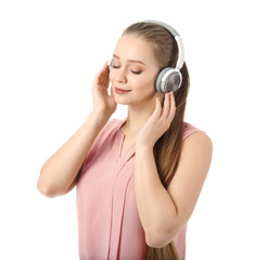 Fototapeta premium Beautiful young woman listening to music on white background