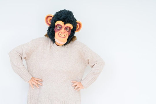 Middle age woman wearing funny and crazy money mask over isolated background with a happy face standing and smiling with a confident smile showing teeth