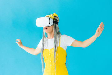 girl with dreadlocks in virtual reality headset Gesturing isolated on turquoise