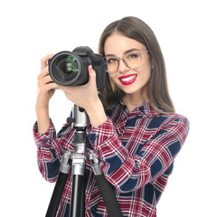 Young female photographer on white background