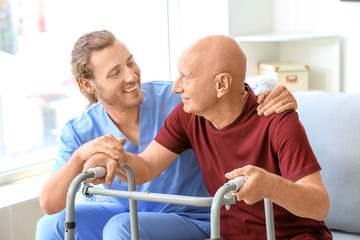 Elderly man with caregiver in nursing home