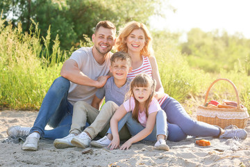 Fototapeta premium Happy family on summer picnic near river