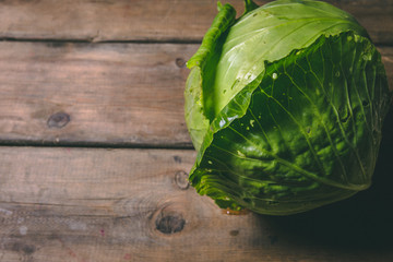 Fototapeta premium Fresh Cabbage on a wooden rustic table. Copy space. Healthy food. Raw Vegetables.