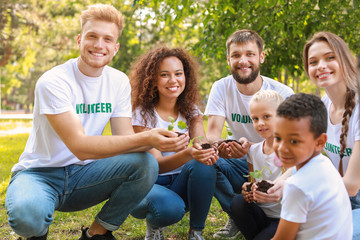 Volunteers with young plants outdoors
