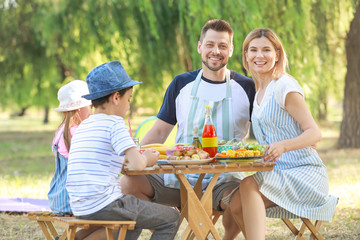 Happy family having picnic on summer day