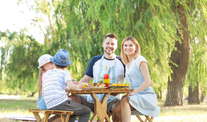 Happy family having picnic on summer day