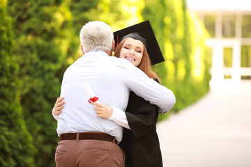 Father greeting his daughter on graduation day