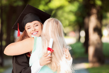 Happy mother greeting her daughter on graduation day