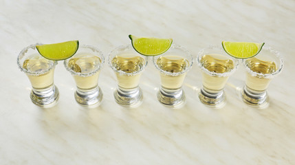 Shots of tequila on light background