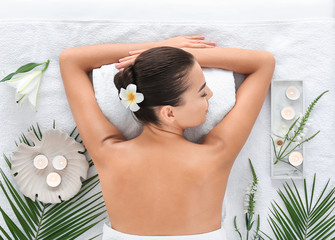 Beautiful young woman relaxing in spa salon